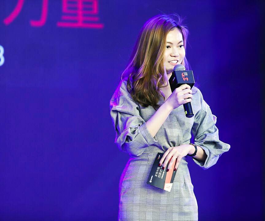 Shi Hui speaking on stage at a business launch in Shanghai